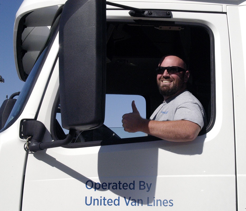 man smiling and sitting in a truck