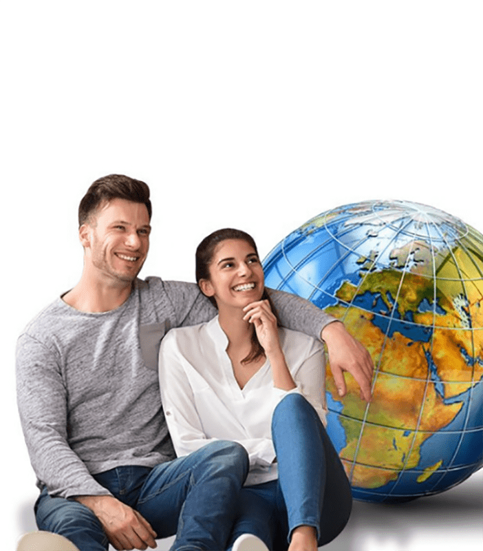man and woman sitting next to a globe