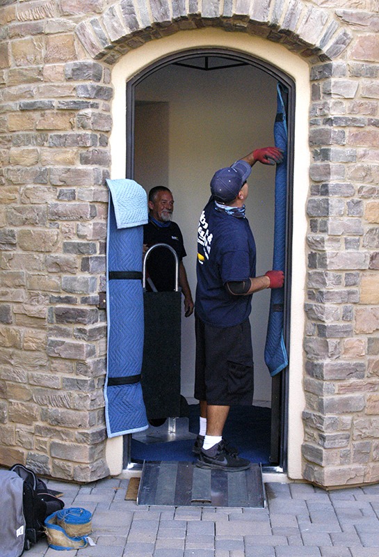 men padding a doorway