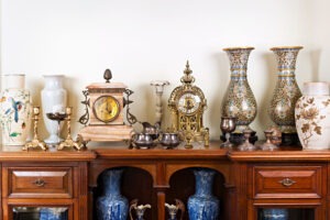 Various antique clocks vases and candlesticks on display